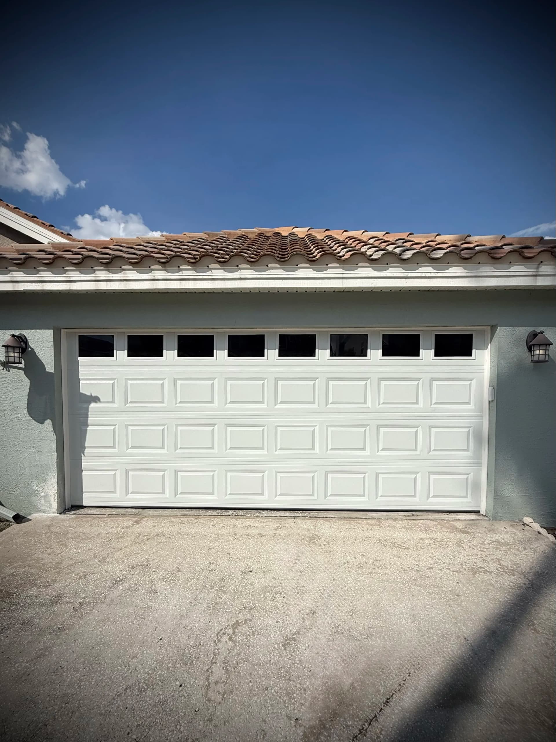 CHI Model 2250 Garage Door Installation with Short Raised Panels and Windows
